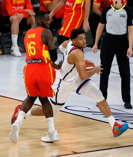 Keldon Johnson of the United States drives against Usman Garuba of Spain during an exhibition game at Michelob ULTRA Arena ahead of the Tokyo Olympic...