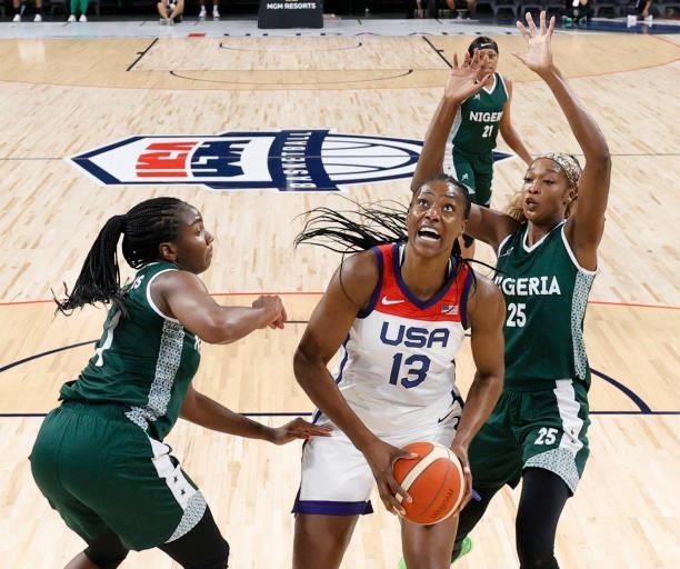 Sylvia Fowles of the United States drives to the basket against Elizabeth Williams and Victoria Macaulay of Nigeria during an exhibition game at...