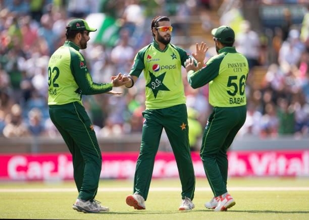 Bowler Imad Wasim of Pakistan is congratulated by team mates Sohaib Maqsood and Babar Azam after getting the wicket of Jason Roy of England during...