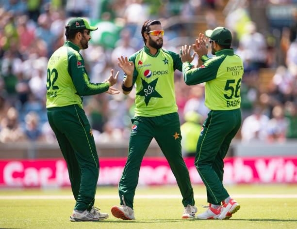 Bowler Imad Wasim of Pakistan is congratulated by team mates Sohaib Maqsood and Babar Azam after getting the wicket of Jason Roy of England during...