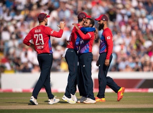 Adil Rashid of England celebrates taking the wicket of Sohaib Maqsood of Pakistan with team mates Dawid Malan, Saqib Mahmood and Moeen Ali during the...