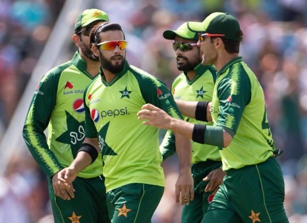 Bowler Imad Wasim of Pakistan is congratulated by team mates Shaheen Afridi, Sohaib Maqsood and Babar Azam after getting the wicket of Jason Roy of...