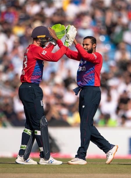 Adil Rashid of England celebrates getting the wicket of Sohaib Maqsood of Pakistan with wicketkeeper Jos Buttler during the 2nd T20I between England...