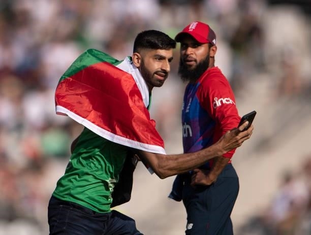 Adil Rashid of England watches a Pakistan fan run on to the field during the 2nd T20I between England and Pakistan at Emerald Headingley Stadium on...