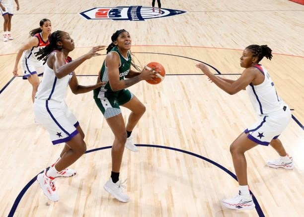 Elizabeth Balogun of Nigeria secures a rebound against Tina Charles and Ariel Atkins of the United States during an exhibition game at Michelob ULTRA...