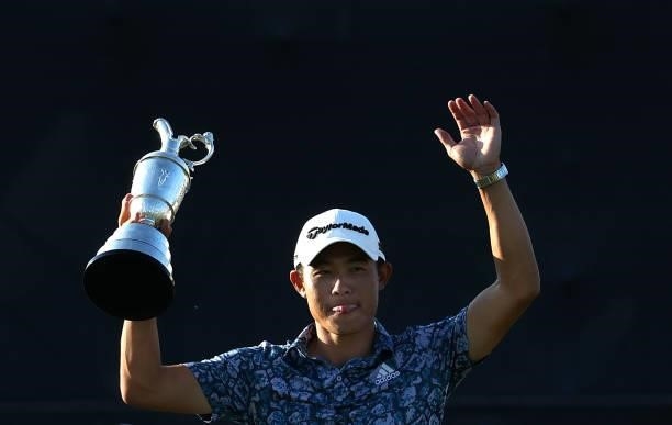 Open Champion, Collin Morikawa of United States acknowledges the crowd on the 18th green holding the Claret Jug after winning The 149th Open at Royal...