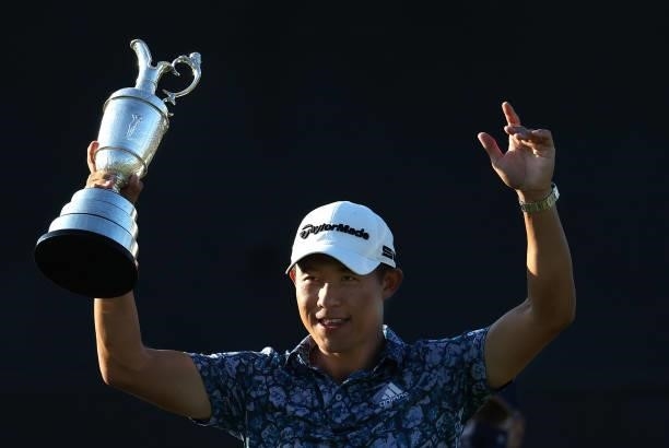Open Champion, Collin Morikawa of United States acknowledges the crowd on the 18th green holding the Claret Jug after winning The 149th Open at Royal...