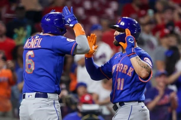 Jeff McNeil and Kevin Pillar of the New York Mets celebrate after Pillar hit a home run in the eleventh inning against the Cincinnati Reds at Great...