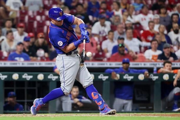 James McCann of the New York Mets hits a single in the tenth inning against the Cincinnati Reds at Great American Ball Park on July 19, 2021 in...
