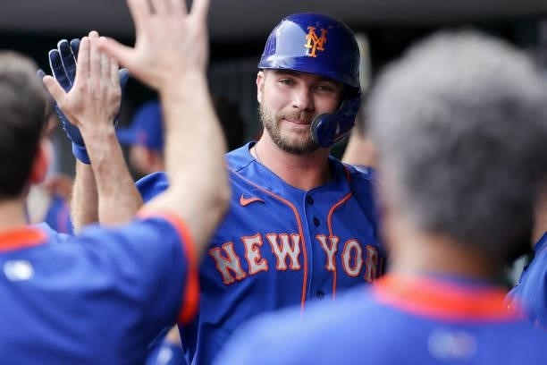 Pete Alonso of the New York Mets celebrates with teammates after hitting a home run in the first inning against the Cincinnati Reds at Great American...