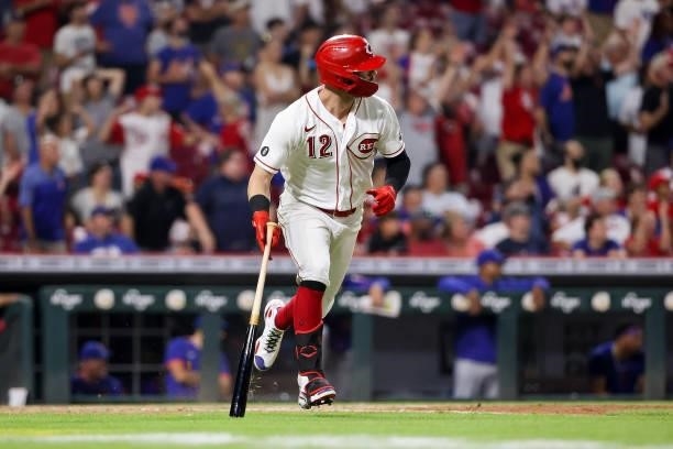 Tyler Naquin of the Cincinnati Reds hits a single in the tenth inning against the New York Mets at Great American Ball Park on July 19, 2021 in...
