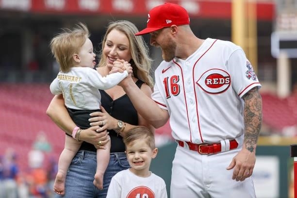 Tucker Barnhart of the Cincinnati Reds and his family meet on the field during a ceremony before the game against the New York Mets at Great American...