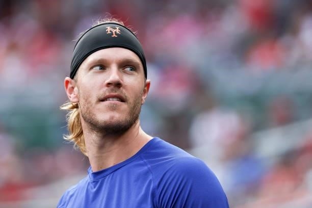 Noah Syndergaard of the New York Mets looks on from the dugout during the game against the Cincinnati Reds at Great American Ball Park on July 19,...