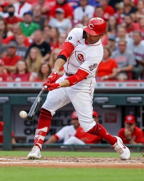Joey Votto of the Cincinnati Reds hits a single in the second inning against the New York Mets at Great American Ball Park on July 19, 2021 in...