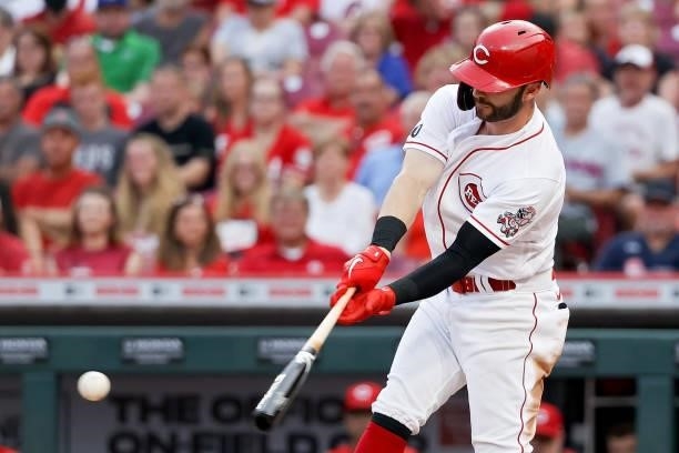 Tyler Naquin of the Cincinnati Reds hits a single in the second inning against the New York Mets at Great American Ball Park on July 19, 2021 in...