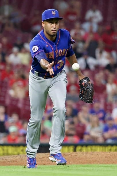 Edwin Diaz of the New York Mets tosses the ball to first base in the eighth inning against the Cincinnati Reds at Great American Ball Park on July...