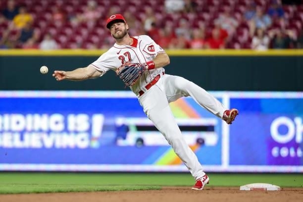 Mike Freeman of the Cincinnati Reds throws to first base in the eleventh inning against the New York Mets at Great American Ball Park on July 19,...