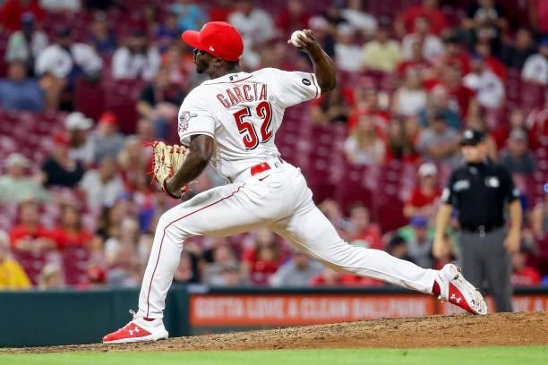 Edgar Garcia of the Cincinnati Reds pitches in the tenth inning against the New York Mets at Great American Ball Park on July 19, 2021 in Cincinnati,...