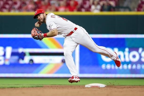Mike Freeman of the Cincinnati Reds throws to first base in the eleventh inning against the New York Mets at Great American Ball Park on July 19,...