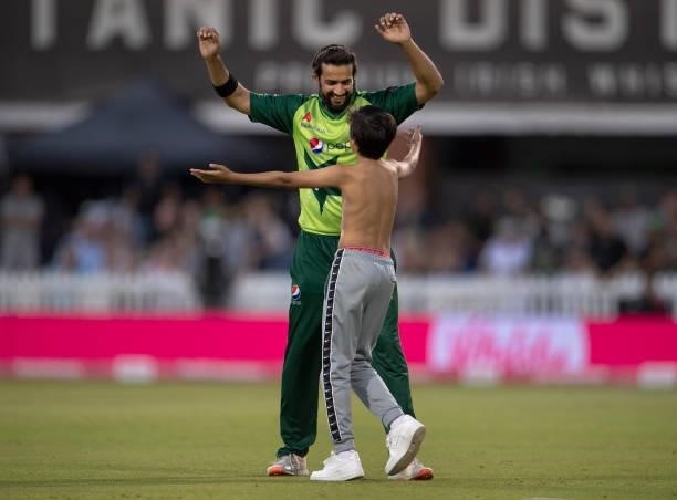Imad Wasim of Pakistan tries to avoid a pitch invader during the 3rd T20I between England and Pakistan at Emirates Old Trafford on July 20, 2021 in...