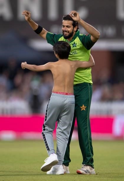 Imad Wasim of Pakistan tries to avoid a pitch invader during the 3rd T20I between England and Pakistan at Emirates Old Trafford on July 20, 2021 in...