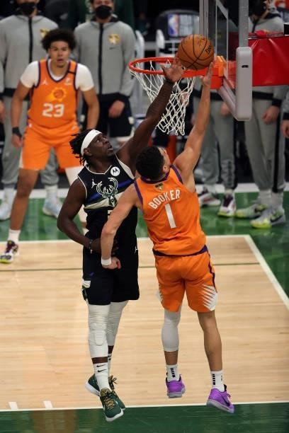 Jrue Holiday of the Milwaukee Bucks defends against Devin Booker of the Phoenix Suns during the first quarter in Game Six of the NBA Finals at Fiserv...