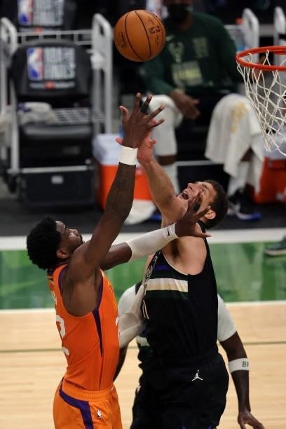 Brook Lopez of the Milwaukee Bucks defends against Deandre Ayton of the Phoenix Suns during the first half in Game Six of the NBA Finals at Fiserv...