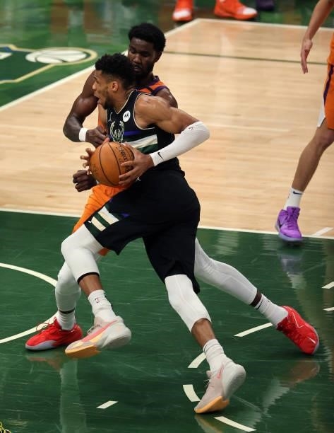 Giannis Antetokounmpo of the Milwaukee Bucks drives to the basket against Deandre Ayton of the Phoenix Suns during the first half in Game Six of the...