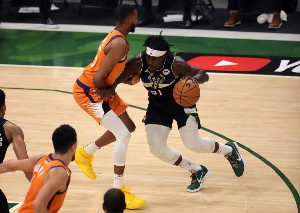 Jrue Holiday of the Milwaukee Bucks drives to the basket against Mikal Bridges of the Phoenix Suns during the first half in Game Six of the NBA...