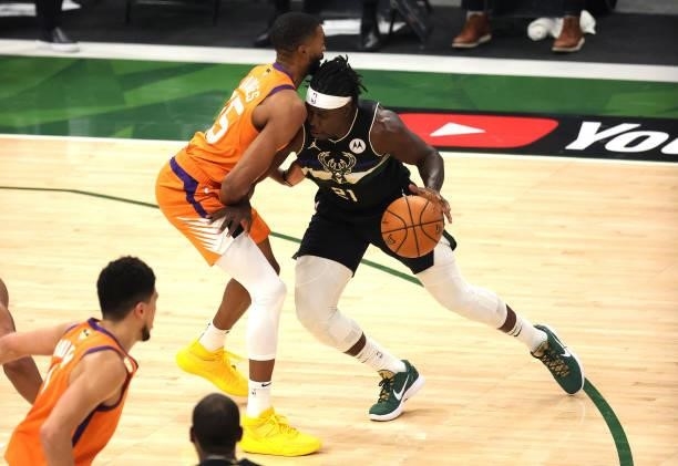 Jrue Holiday of the Milwaukee Bucks drives into Mikal Bridges of the Phoenix Suns during the first half in Game Six of the NBA Finals at Fiserv Forum...