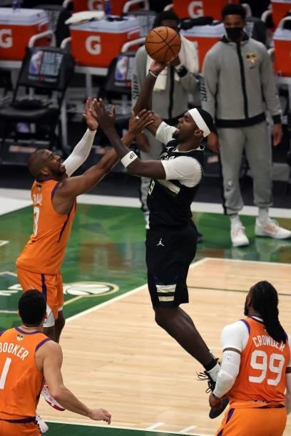 Bobby Portis of the Milwaukee Bucks shoots against Chris Paul of the Phoenix Suns during the first half in Game Six of the NBA Finals at Fiserv Forum...