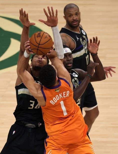 Giannis Antetokounmpo of the Milwaukee Bucks defends against Devin Booker of the Phoenix Suns during the first half in Game Six of the NBA Finals at...