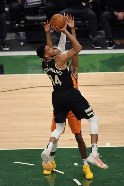 Giannis Antetokounmpo of the Milwaukee Bucks goes up for a shot against Mikal Bridges of the Phoenix Suns during the second half in Game Six of the...