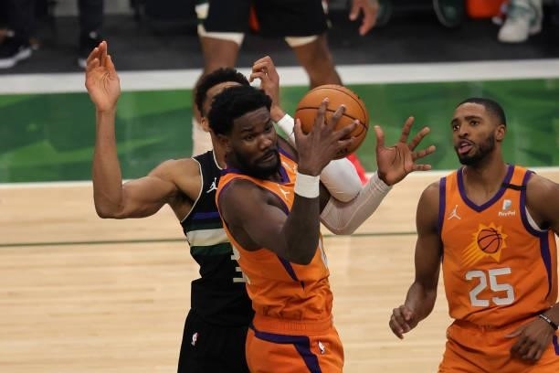 Deandre Ayton of the Phoenix Suns is defended by Giannis Antetokounmpo of the Milwaukee Bucks during the second half in Game Six of the NBA Finals at...