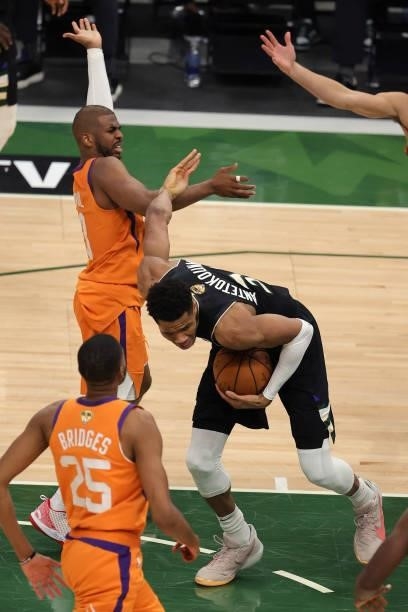 Giannis Antetokounmpo of the Milwaukee Bucks tangles with Chris Paul of the Phoenix Suns during the second half in Game Six of the NBA Finals at...