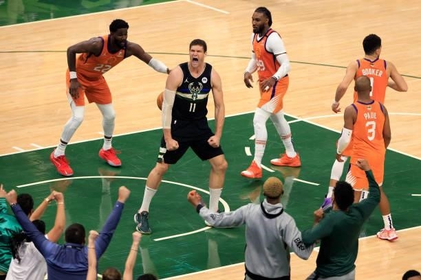 Brook Lopez of the Milwaukee Bucks reacts to a dunk against the Phoenix Suns during the second half in Game Six of the NBA Finals at Fiserv Forum on...