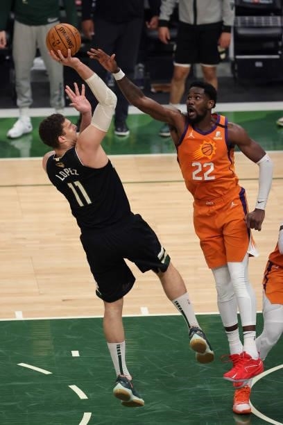 Brook Lopez of the Milwaukee Bucks shoots against Deandre Ayton of the Phoenix Suns during the second half in Game Six of the NBA Finals at Fiserv...