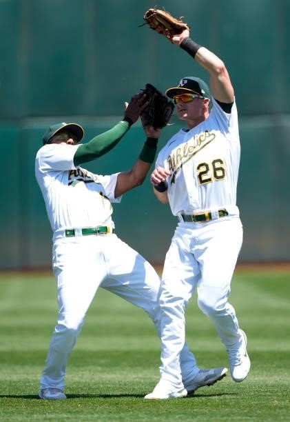 Matt Chapman of the Oakland Athletics avoids colliding with Elvis Andrus while catching a pop-up off the bat of Jared Walsh of the Los Angeles Angels...
