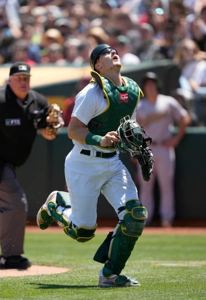 Sean Murphy of the Oakland Athletics chases after a foul pop-up off the bat of Luis Rengifo of the Los Angeles Angels in the top of the fourth inning...