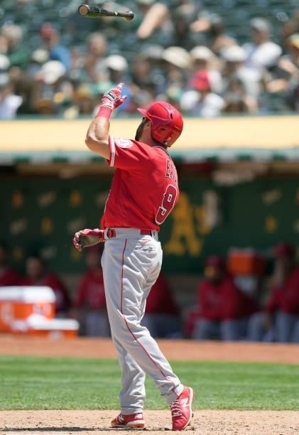 Adam Eaton of the Los Angeles Angels tosses his bat in the air reacting after he was called out on strike against the Oakland Athletics in the top of...