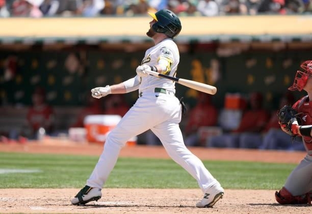 Jed Lowrie of the Oakland Athletics hits a sacrifice fly scoring Tony Kemp against the Los Angeles Angels in the bottom of the six inning at...