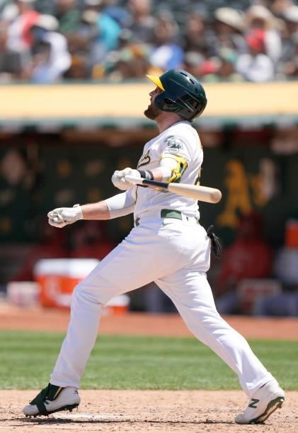 Jed Lowrie of the Oakland Athletics hits a sacrifice fly scoring Tony Kemp against the Los Angeles Angels in the bottom of the six inning at...