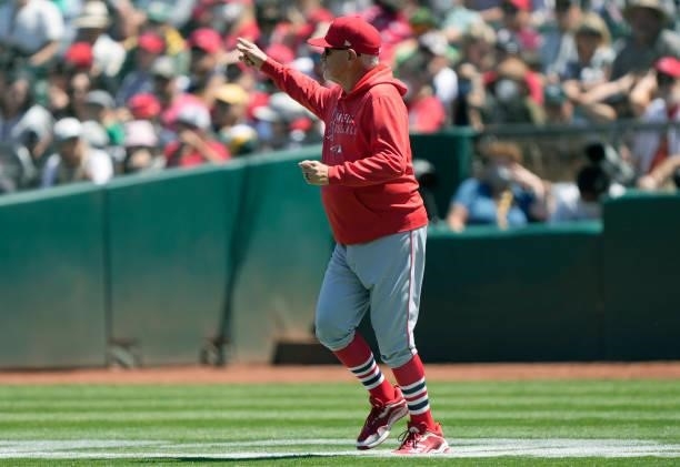 Manager Joe Maddon of the Los Angeles Angels signals the bullpen to make a pitching change against the Oakland Athletics in the bottom of the six...
