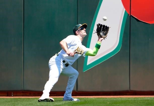 Mark Canha of the Oakland Athletics catches a fly ball off the bat of Brandon Marsh of the Los Angeles Angels in the top of the second inning at...