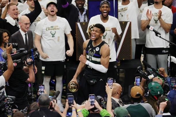 Giannis Antetokounmpo of the Milwaukee Bucks celebrates winning the Bill Russell NBA Finals MVP Award after defeating the Phoenix Suns in Game Six to...