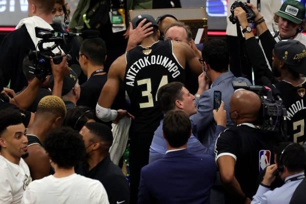 Giannis Antetokounmpo of the Milwaukee Bucks hugs head coach Mike Budenholzer after defeating the Phoenix Suns in Game Six to win the 2021 NBA Finals...