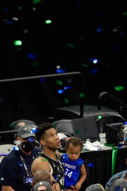 Giannis Antetokounmpo of the Milwaukee Bucks holds his son Liam Charles Antetokounmpo after defeating the Phoenix Suns in Game Six to win the 2021...