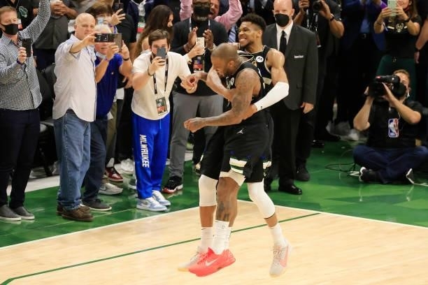 Giannis Antetokounmpo of the Milwaukee Bucks celebrates with teammate P.J. Tucker of the Milwaukee Bucks in the final second before defeating the...