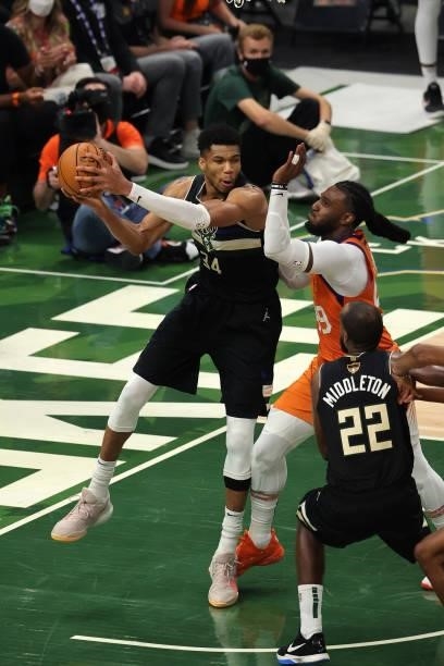 Giannis Antetokounmpo of the Milwaukee Bucks is pressured by Jae Crowder of the Phoenix Suns during the second half in Game Six of the NBA Finals at...