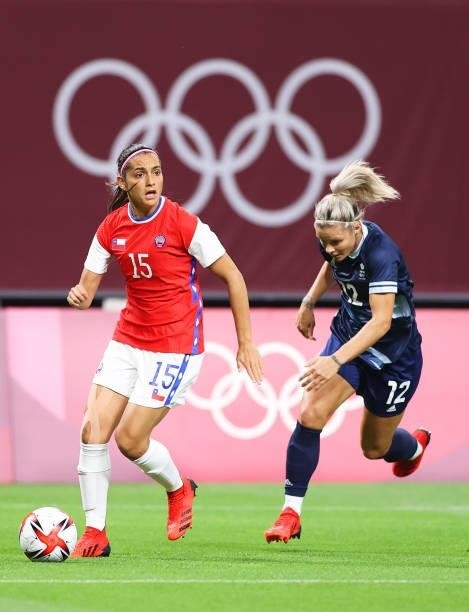 Daniela Zamora of Team Chile runs with the ball whilst under pressure from Rachel Daly of Team Great Britain during the Women's First Round Group E...